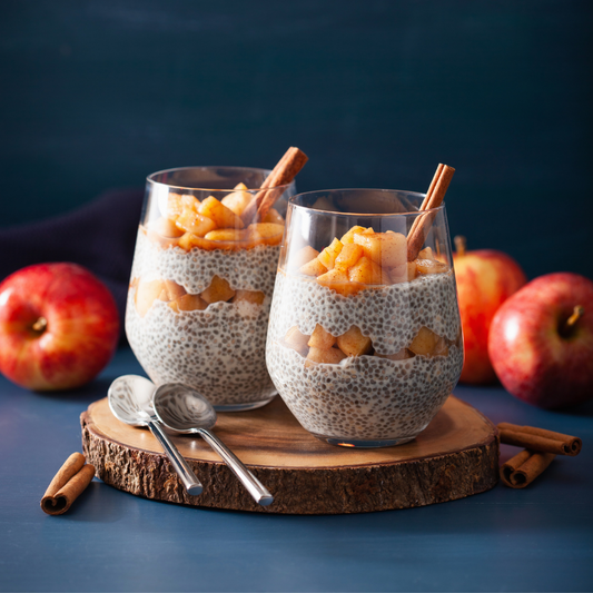 Two glass goblets of Overnight Apple Pie Protein Chia Pudding