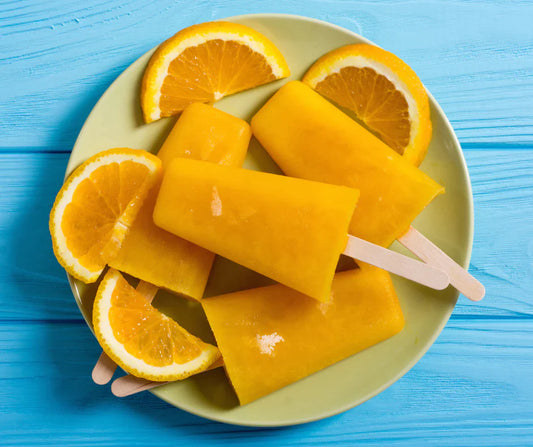 Orange Creamsicle Protein Pop on a plate of orange slices
