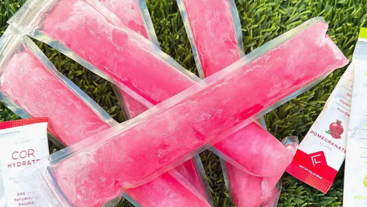 Frozen Pink Boozy Otter Pops in plastic packaging