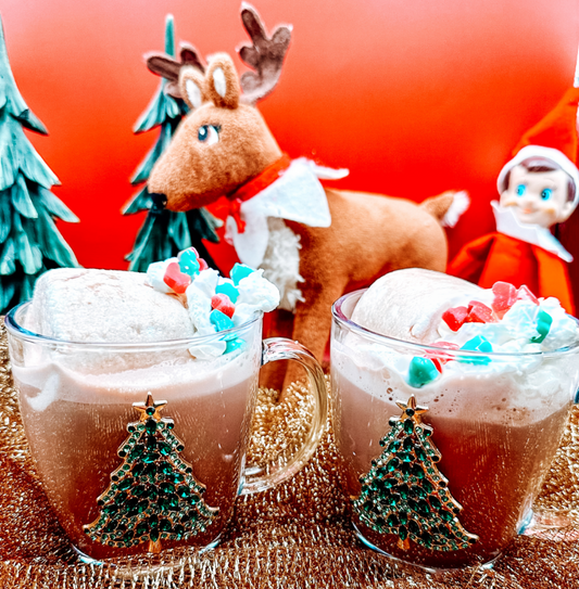 Two Christmas themed glasses of Protein Hot Chocolate with a reindeer and an elf.