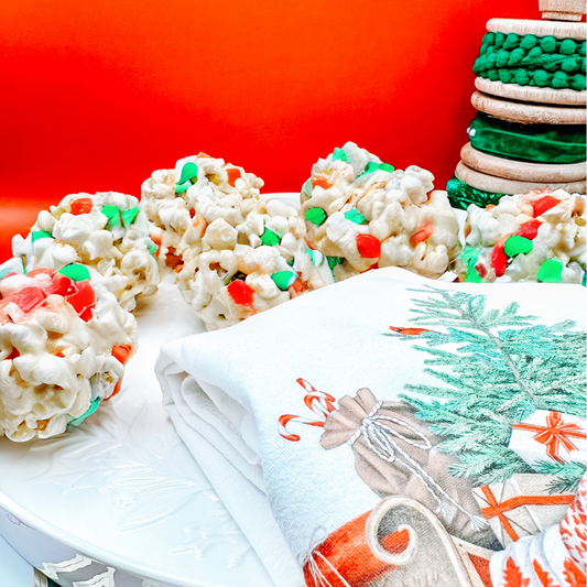 A table full of colorful Holiday Popcorn Balls