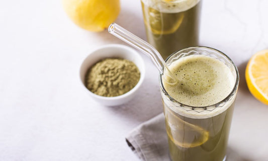 A smoothie with NRG in a glass with a stirring spoon is delicious and nutricious.