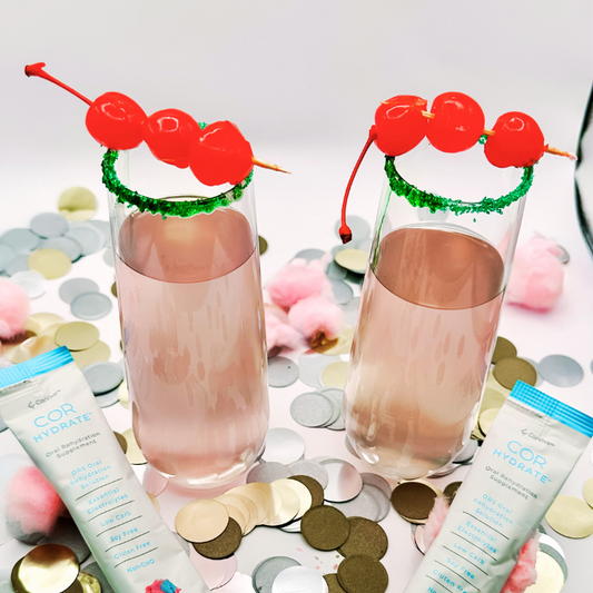 Two tall glasses of Cotton Candy Mocktail with maraschino cherries.