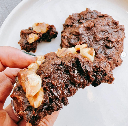 Guilt-free Chocolate Protein Cookies topped with walnuts.